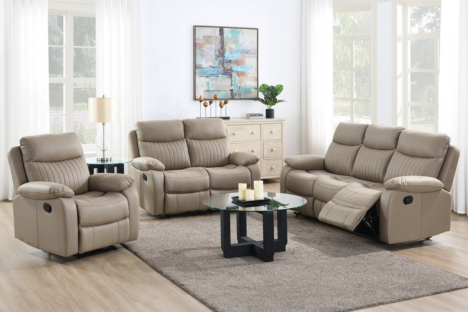 Beige reclining sofa set in a living room with a coffee table and decor.