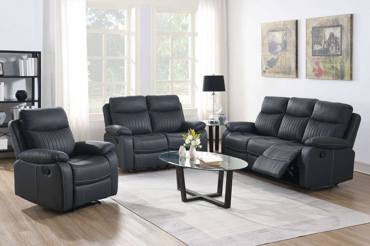 Dark Grey leather reclining sofa set in a living room with a coffee table and decor.