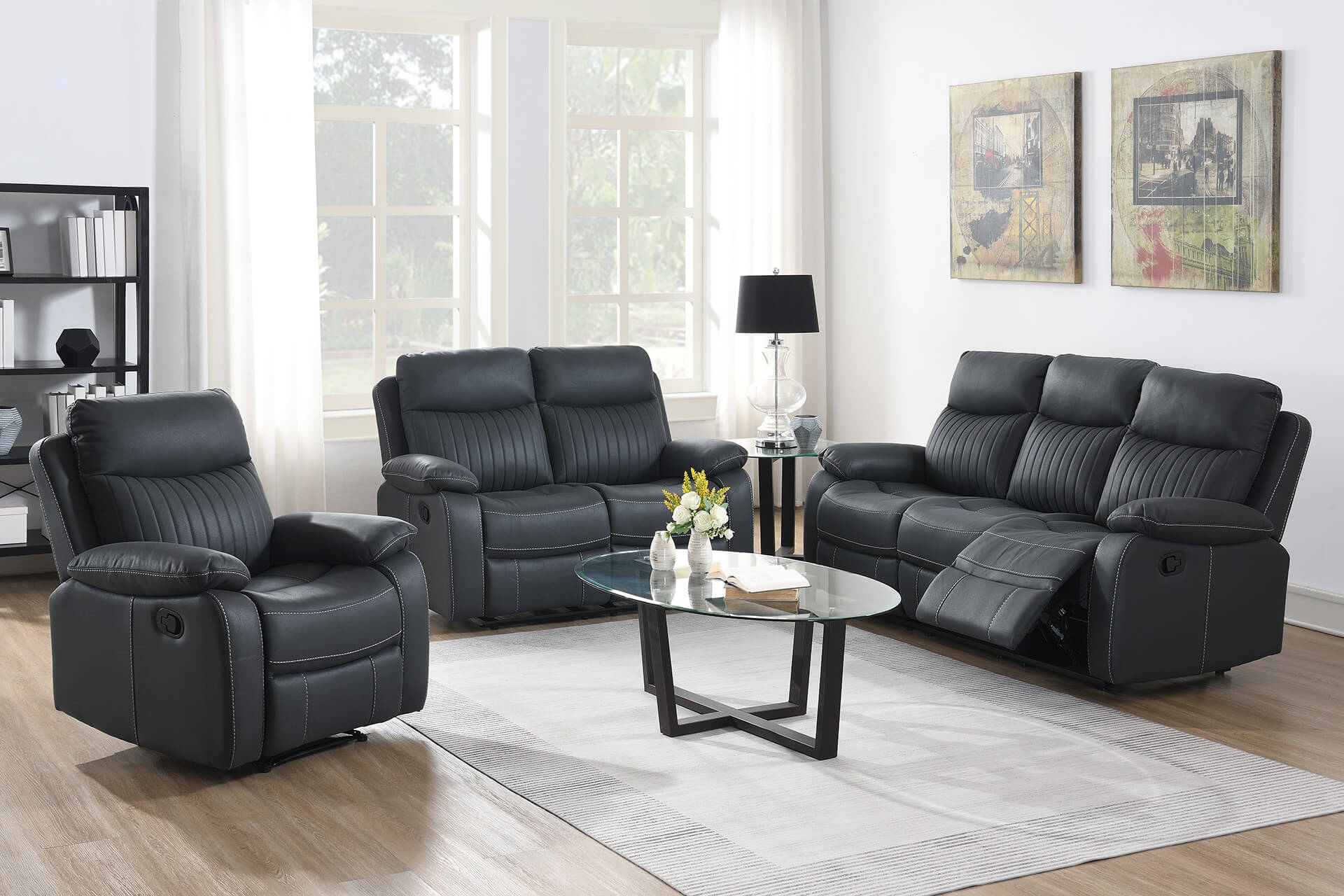 Dark Grey leather reclining sofa set in a living room with a coffee table and decor.
