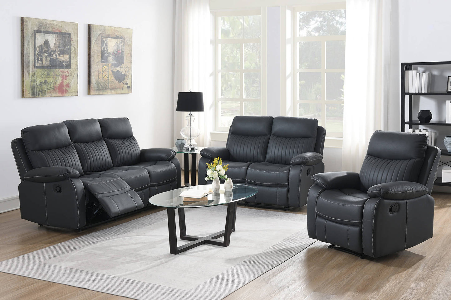 Dark Grey leather reclining sofa set in a living room with a coffee table and decor.