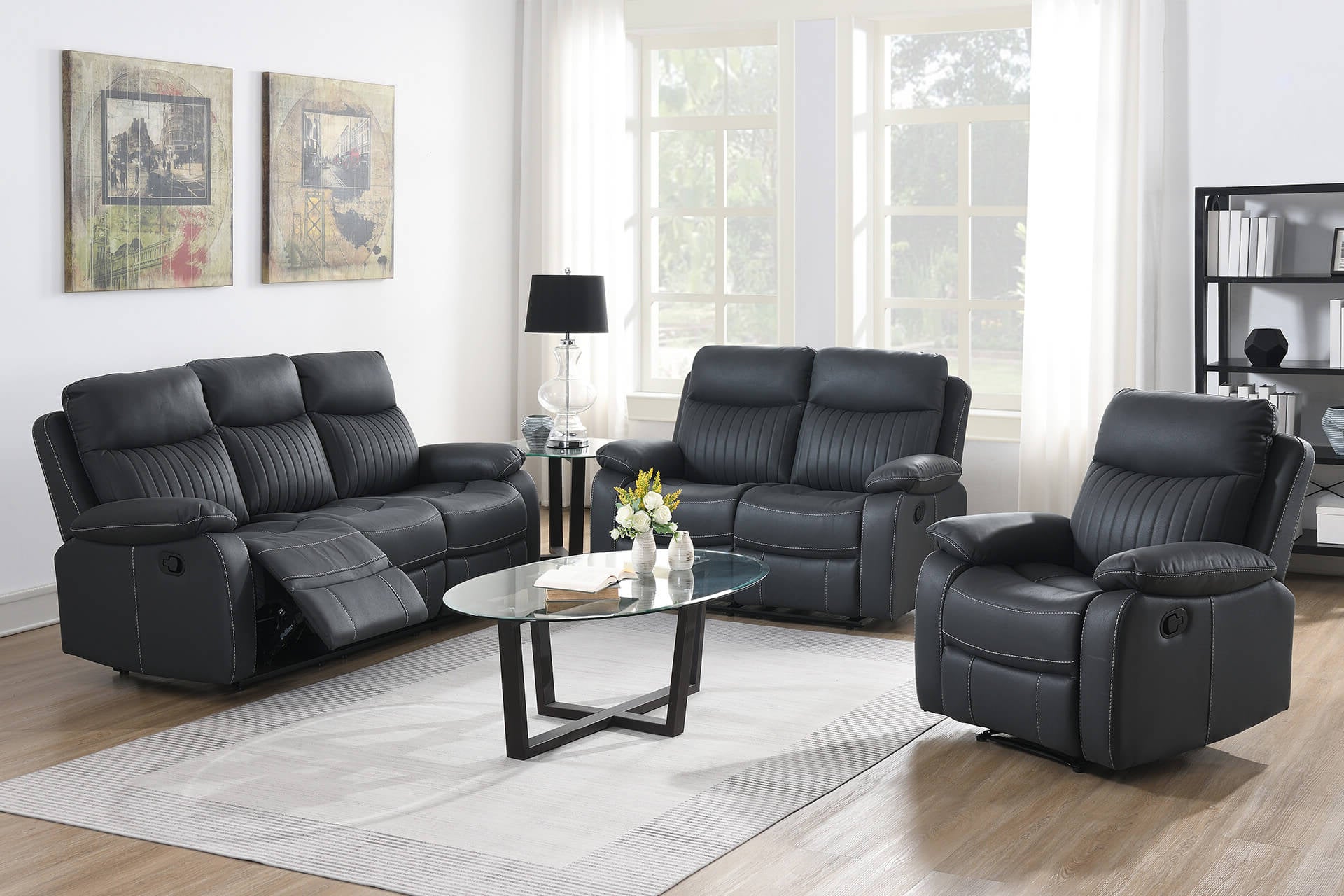 Dark Grey leather reclining sofa set in a living room with a coffee table and decor.